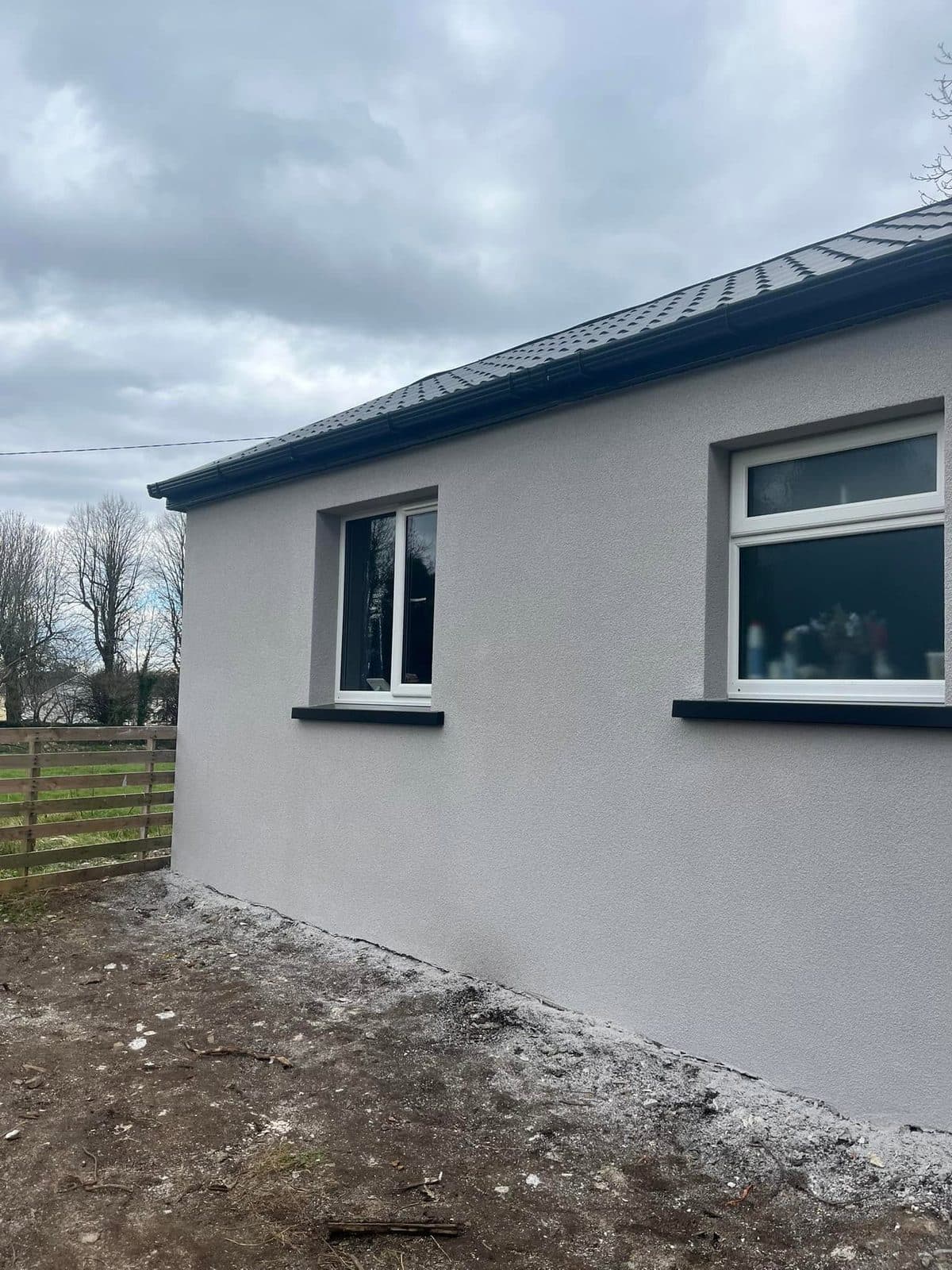 Bungalow with a smooth grey external render finish
