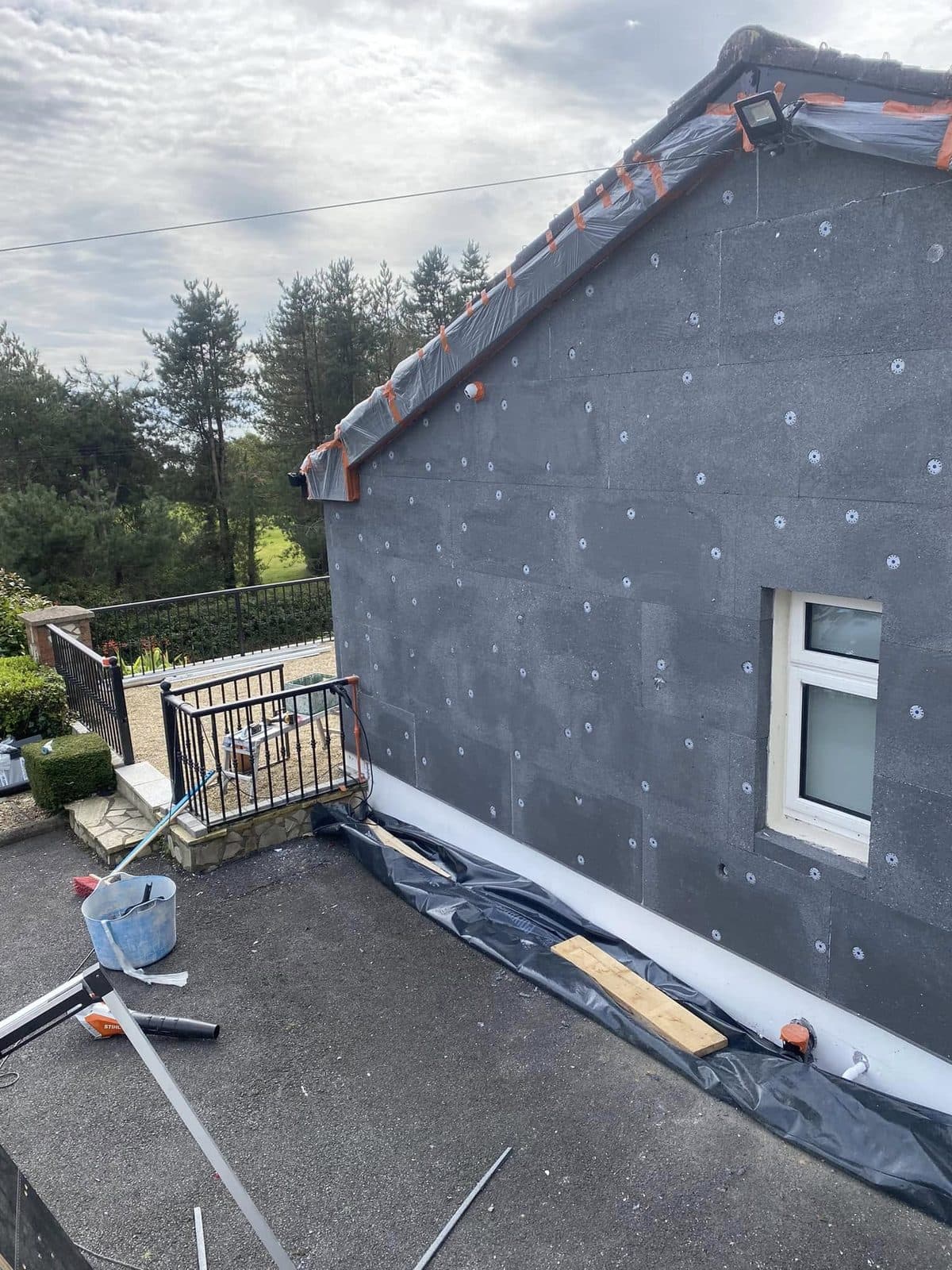 Insulation boards fixed to the outside wall of a house during external wall insulation